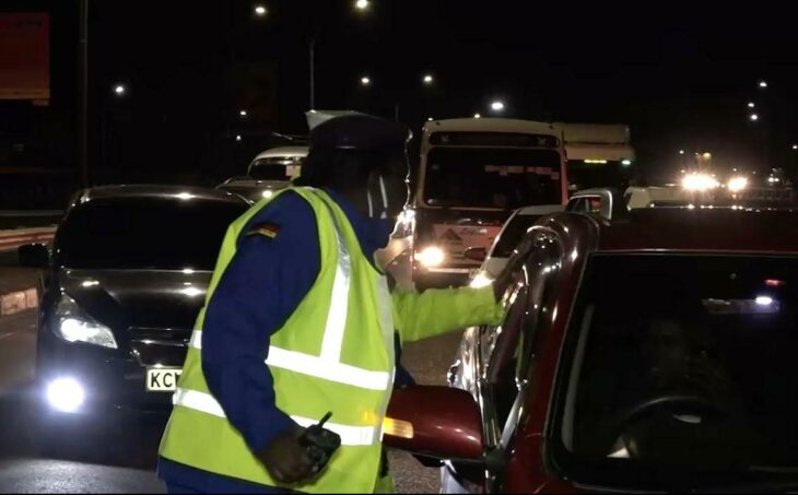 Traffic Police officer questioning motorist while enforcing curfew protocols.Photo/Courtesy